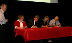 four people signing the partnership agreement